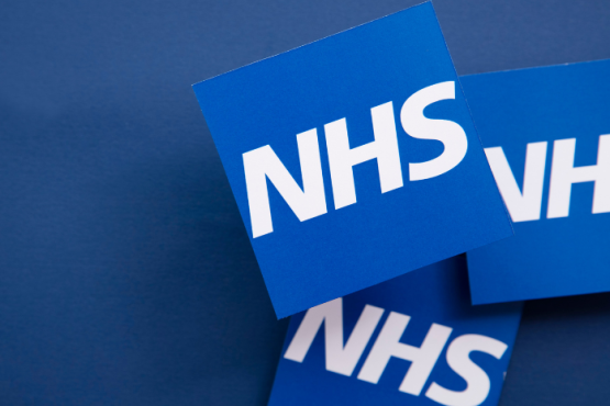 National Health Service symbol shown 3 times overlapping on a dark blue background
